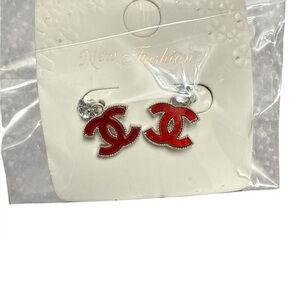 CC Red earrings with silver accents .